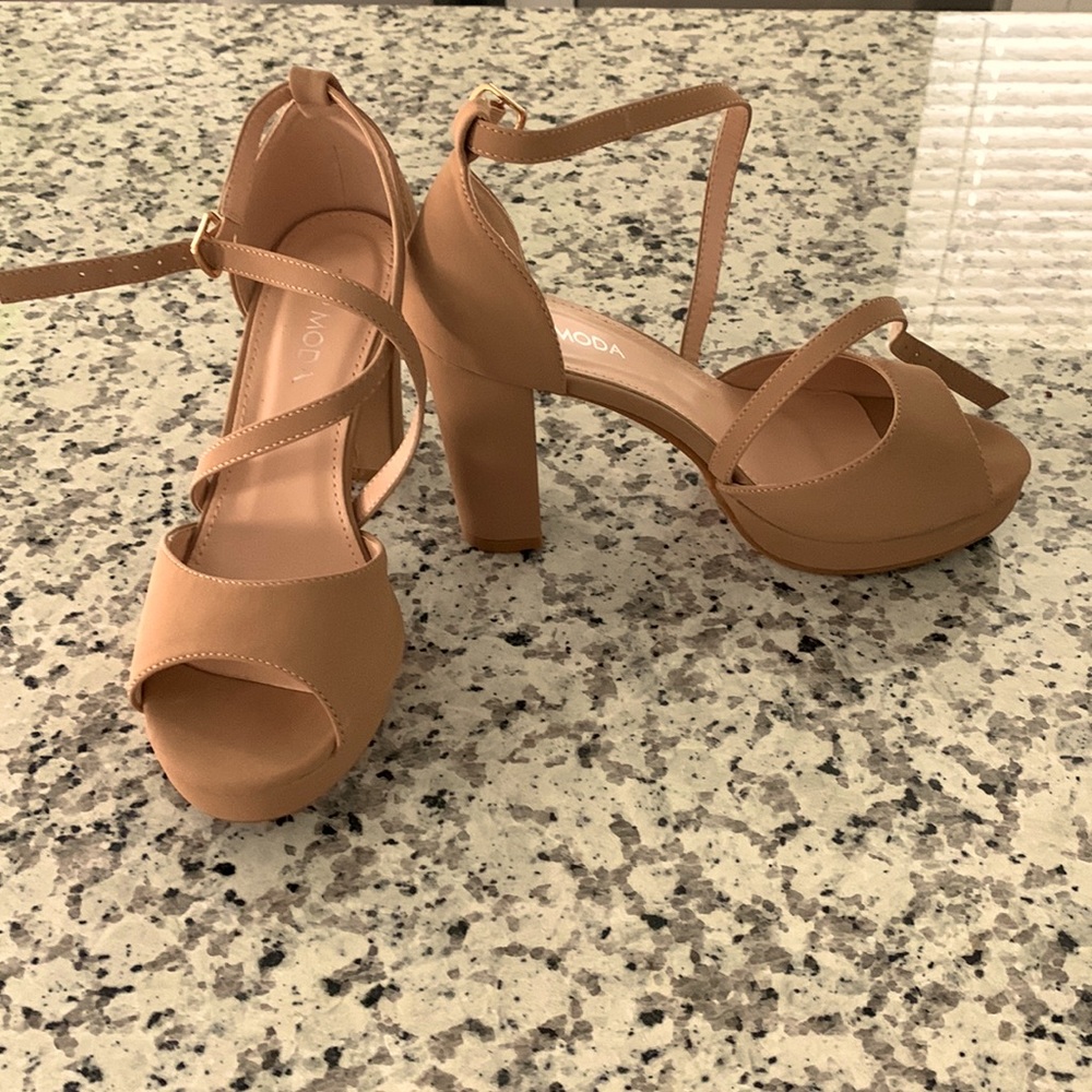 Women’s beige heels with straps . Perfect for sun dresses or a pair of jeans .